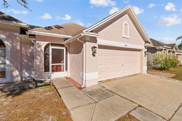 1202 Sawdust Ct, Valrico, FL 33596 - view of front of home featuring a garage, stucco siding, driveway, and roof with shingles