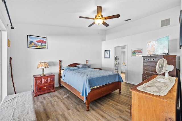 bedroom featuring ceiling fan, hardwood / wood-style floors, and vaulted ceiling