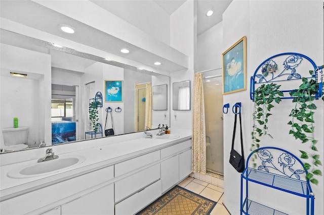 bathroom with tile patterned flooring, vanity, an enclosed shower, and toilet