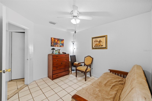 living area featuring ceiling fan and light tile patterned floors