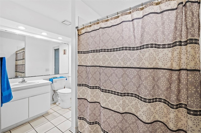 bathroom with tile patterned flooring, vanity, and toilet