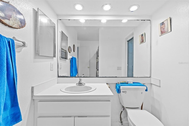 bathroom featuring vanity and toilet