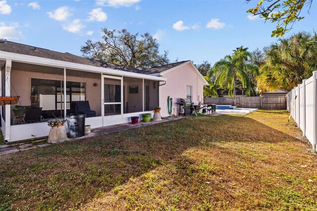 1202 Sawdust Ct, Valrico, FL 33596 - back of property featuring a sunroom, a fenced backyard, stucco siding, and a patio area