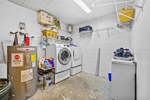 washroom with washing machine and dryer and water heater