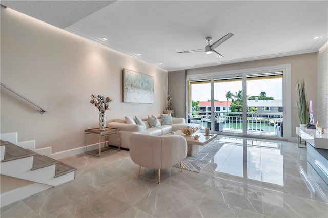 living room with ceiling fan, a water view, and crown molding