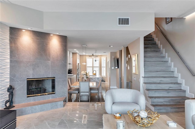 living room with tile walls and a tile fireplace