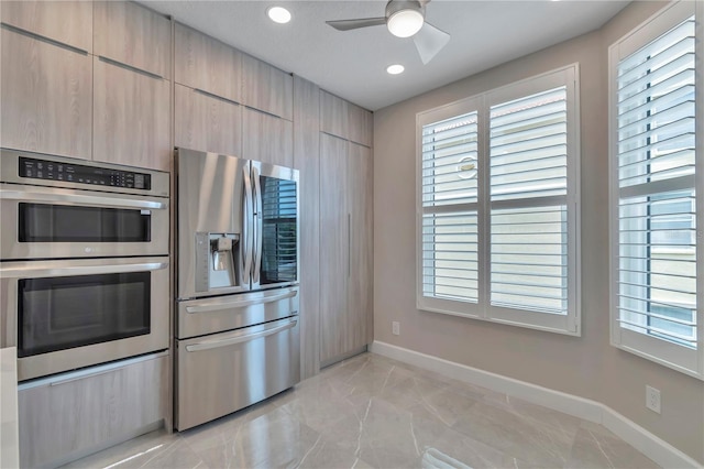 kitchen featuring ceiling fan, light brown cabinets, and appliances with stainless steel finishes