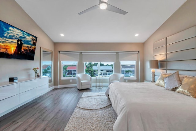 bedroom with ceiling fan, dark hardwood / wood-style flooring, and lofted ceiling