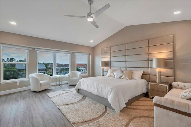 bedroom featuring ceiling fan, light wood-type flooring, and lofted ceiling