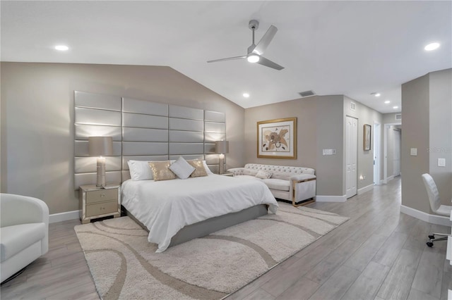 bedroom featuring ceiling fan, light hardwood / wood-style flooring, and vaulted ceiling