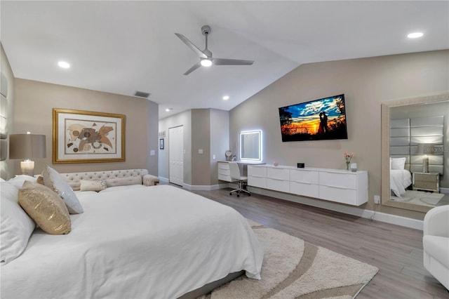 bedroom with ceiling fan, light hardwood / wood-style floors, and lofted ceiling