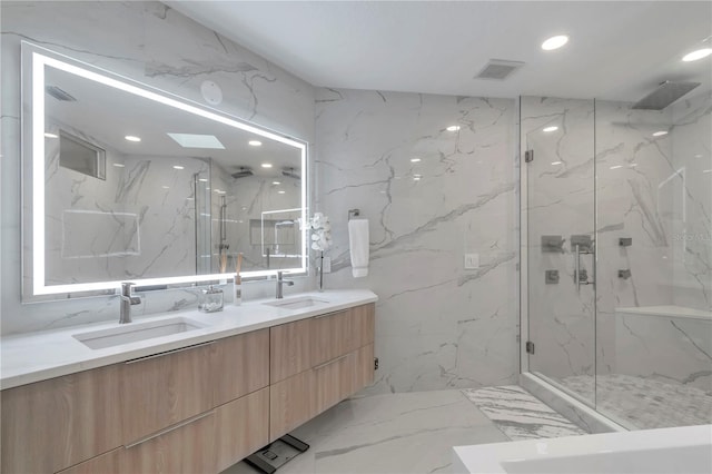 bathroom with vanity, tile walls, walk in shower, and a skylight