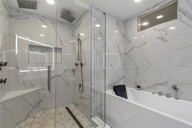 bathroom featuring plus walk in shower and tile walls