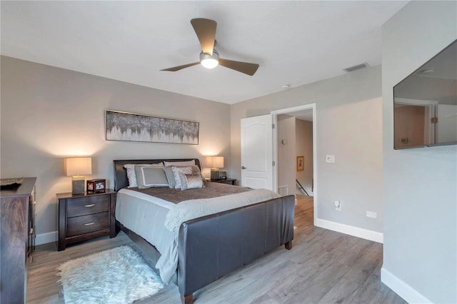 bedroom with ceiling fan and light hardwood / wood-style flooring