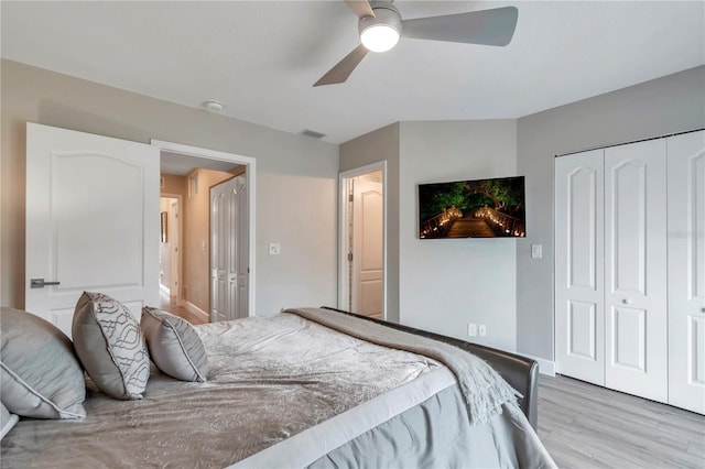 bedroom featuring a closet, light hardwood / wood-style flooring, and ceiling fan