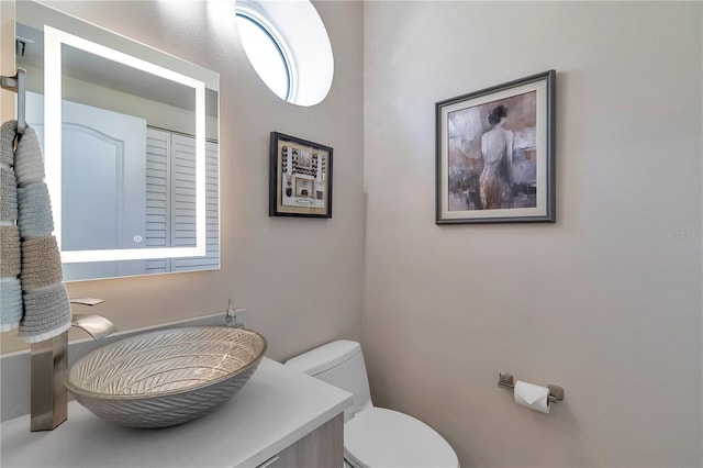 bathroom featuring vanity and toilet