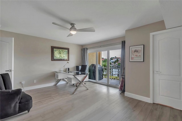 office space featuring ceiling fan and light wood-type flooring