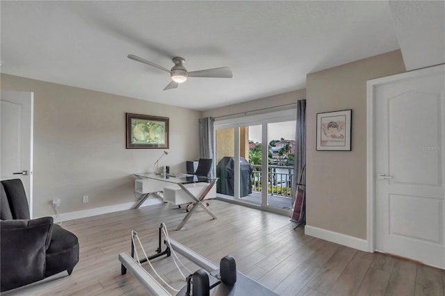 home office with ceiling fan and light wood-type flooring