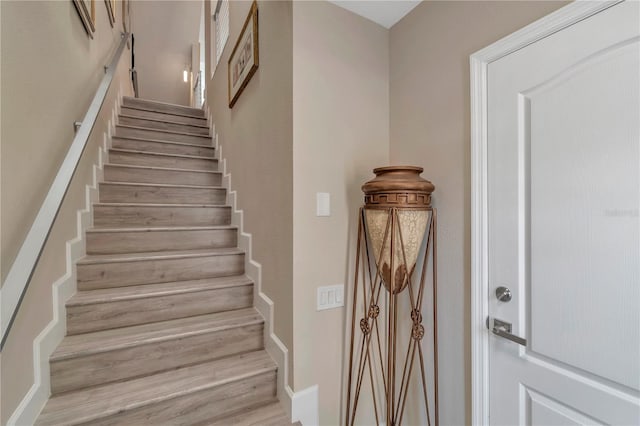 stairway with hardwood / wood-style flooring