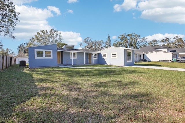 ranch-style house featuring central AC unit and a front lawn