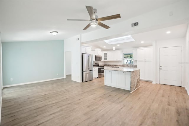 2537 Martha Ln, Land O Lakes, FL 34639 - kitchen with appliances with stainless steel finishes, a ceiling fan, white cabinets, a kitchen island, and recessed lighting