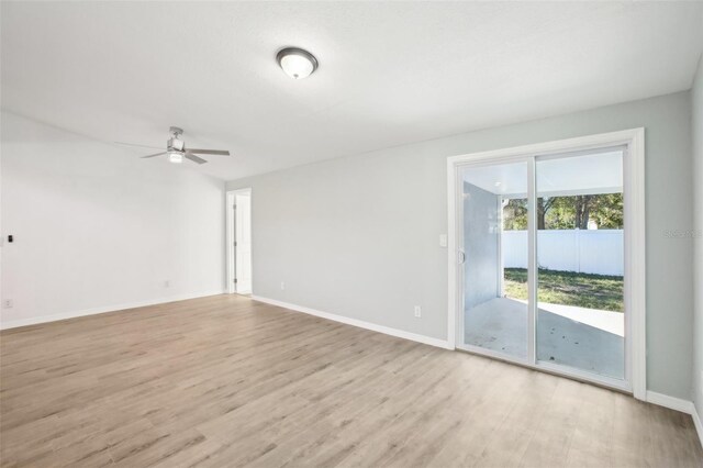 2537 Martha Ln, Land O Lakes, FL 34639 - unfurnished room with light wood-style floors, a ceiling fan, and baseboards
