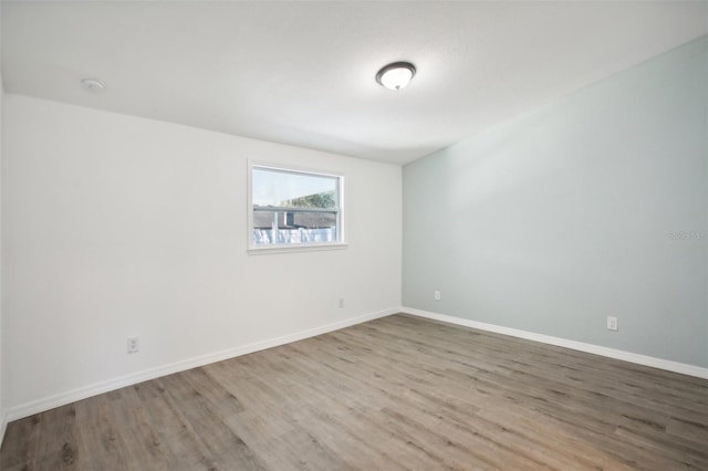 unfurnished room with wood-type flooring