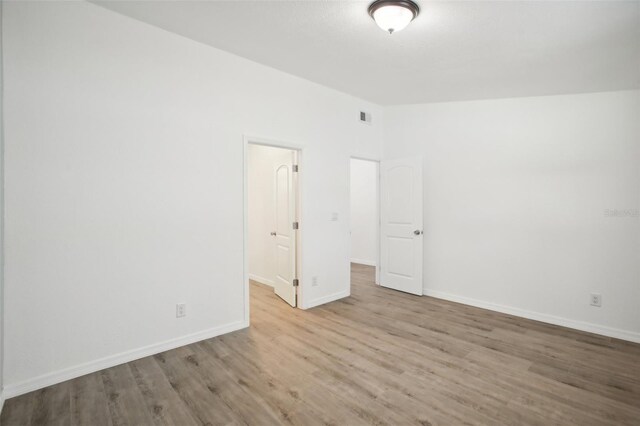 2537 Martha Ln, Land O Lakes, FL 34639 - unfurnished room featuring wood finished floors and baseboards