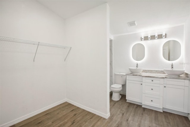 bathroom featuring hardwood / wood-style flooring, vanity, and toilet