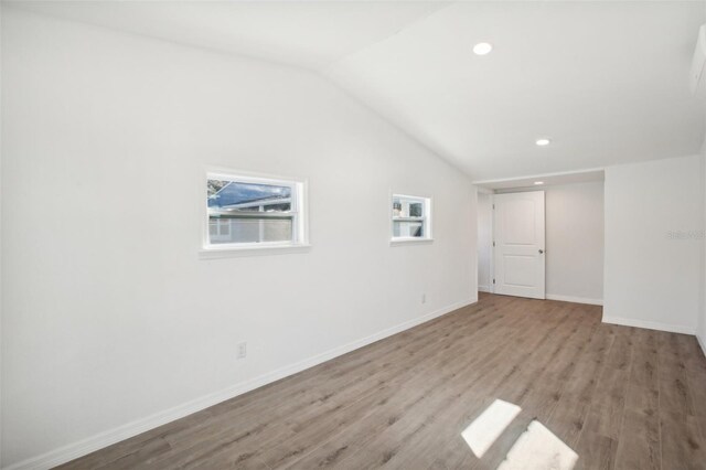 2537 Martha Ln, Land O Lakes, FL 34639 - unfurnished room featuring wood finished floors, lofted ceiling, baseboards, and recessed lighting