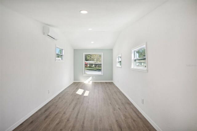2537 Martha Ln, Land O Lakes, FL 34639 - hallway featuring a wall mounted AC, wood finished floors, baseboards, and recessed lighting