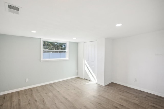 empty room with hardwood / wood-style floors