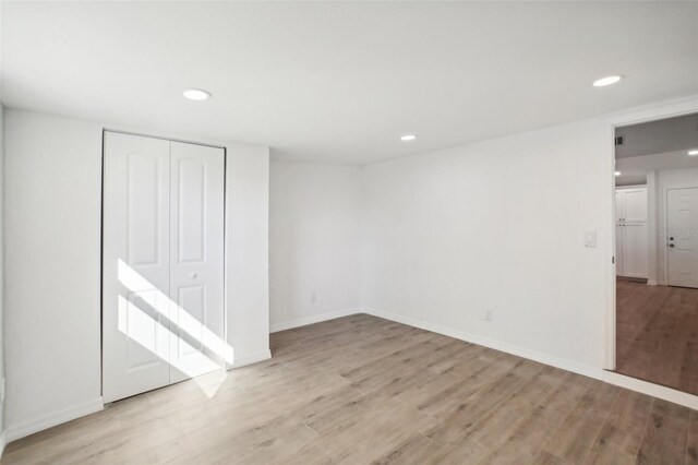 2537 Martha Ln, Land O Lakes, FL 34639 - unfurnished bedroom with light wood-style floors, recessed lighting, a closet, and baseboards