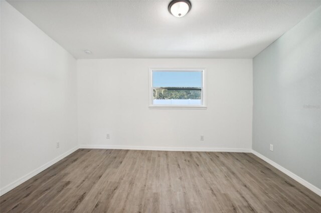 2537 Martha Ln, Land O Lakes, FL 34639 - spare room featuring wood finished floors and baseboards