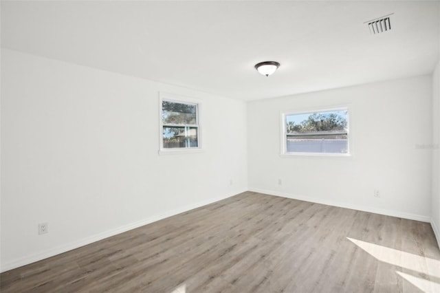 unfurnished room with light hardwood / wood-style flooring