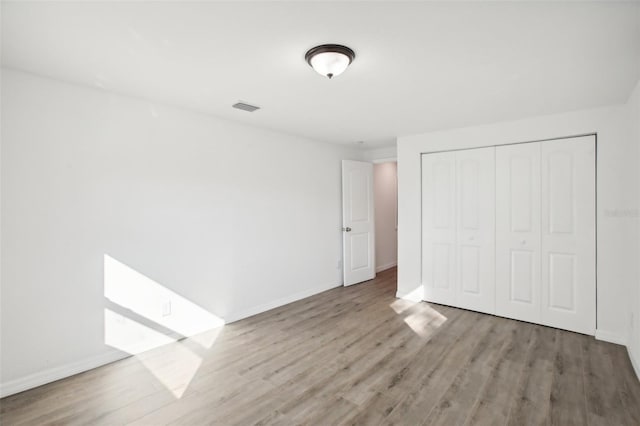 2537 Martha Ln, Land O Lakes, FL 34639 - unfurnished bedroom with wood finished floors and baseboards
