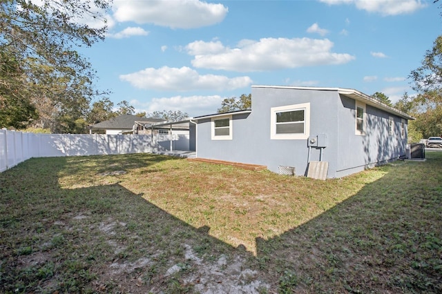 rear view of property with a lawn