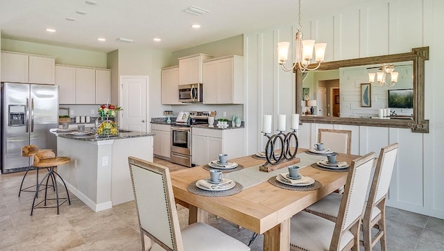 dining space with light tile patterned floors and a notable chandelier