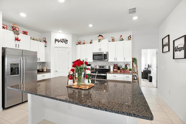 kitchen with light tile patterned floors, visible vents, white cabinetry, and stainless steel appliances