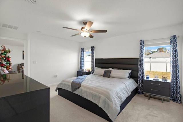 bedroom with baseboards, carpet, visible vents, and a ceiling fan