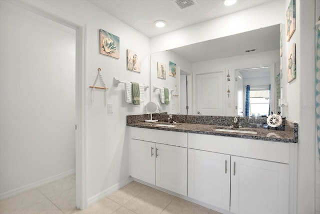 bathroom featuring double vanity, visible vents, a sink, and tile patterned floors