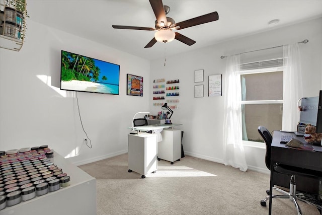 office area with ceiling fan, baseboards, and light colored carpet