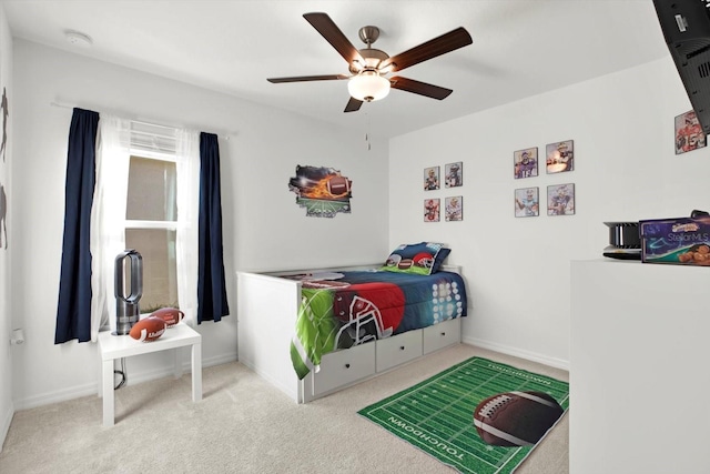 bedroom with a ceiling fan, carpet, and baseboards