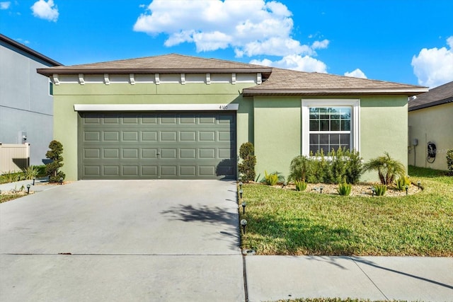 view of front of house with a garage, concrete driveway, a front lawn, and stucco siding