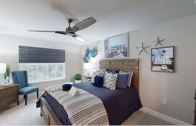 bedroom featuring ceiling fan, light carpet, and a textured ceiling