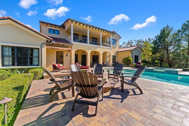 view of swimming pool featuring an in ground hot tub and a patio area