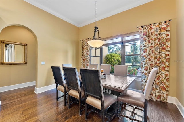 dining room featuring dark hardwood / wood-style flooring and crown molding