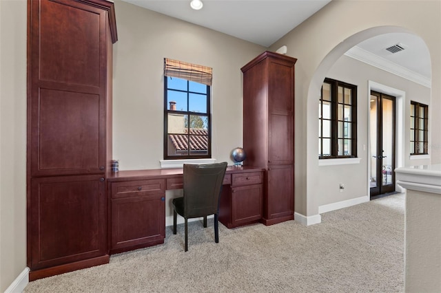 office featuring light colored carpet, built in desk, crown molding, and french doors