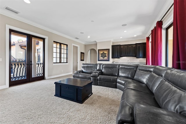 living room featuring french doors, carpet floors, and crown molding