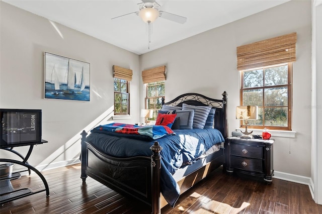 bedroom with dark hardwood / wood-style floors, multiple windows, and ceiling fan